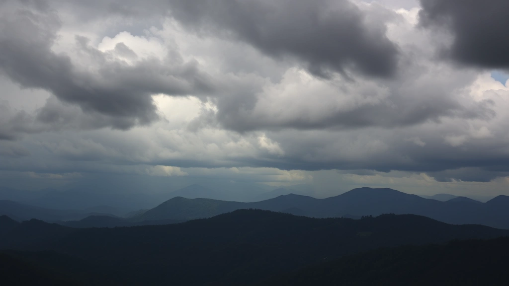 Dramatic storm clouds rolling over Blue Ridge Mountains near Asheville North Carolina, dark thunderheads building above forested peaks, moody atmospheric mountain landscape, cinematic weather photography
