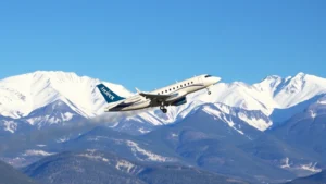Regional Bombardier CRJ aircraft taking off from high-elevation Aspen-Pitkin County Airport surrounded by snow-capped Rocky Mountains under clear blue sky