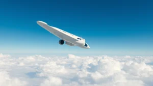 Wide-angle shot of modern commercial aircraft in flight against clear blue sky with white clouds below, showing sleek fuselage and extended wings, dramatic lighting emphasizing the aircraft's engineering